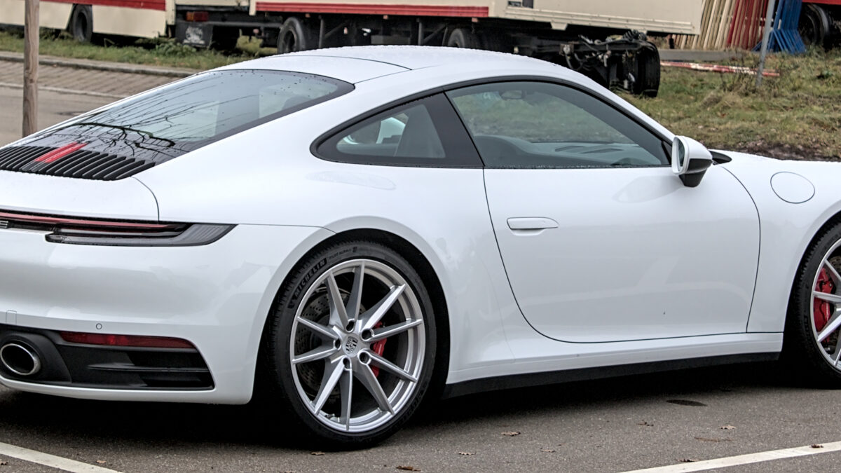 Srebrne Porsche 911 Carrera S coupé generacji 992, widok z boku